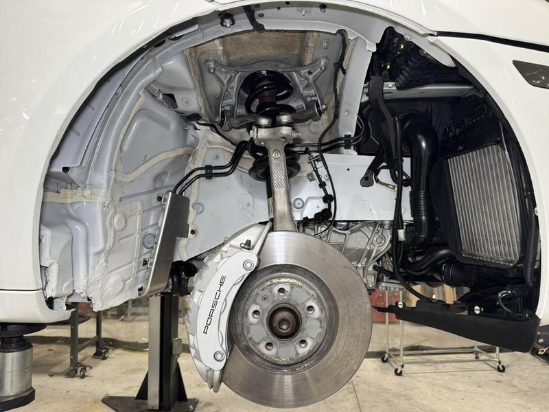 Front wheel well detail showing coated liner and Porsche brake caliper